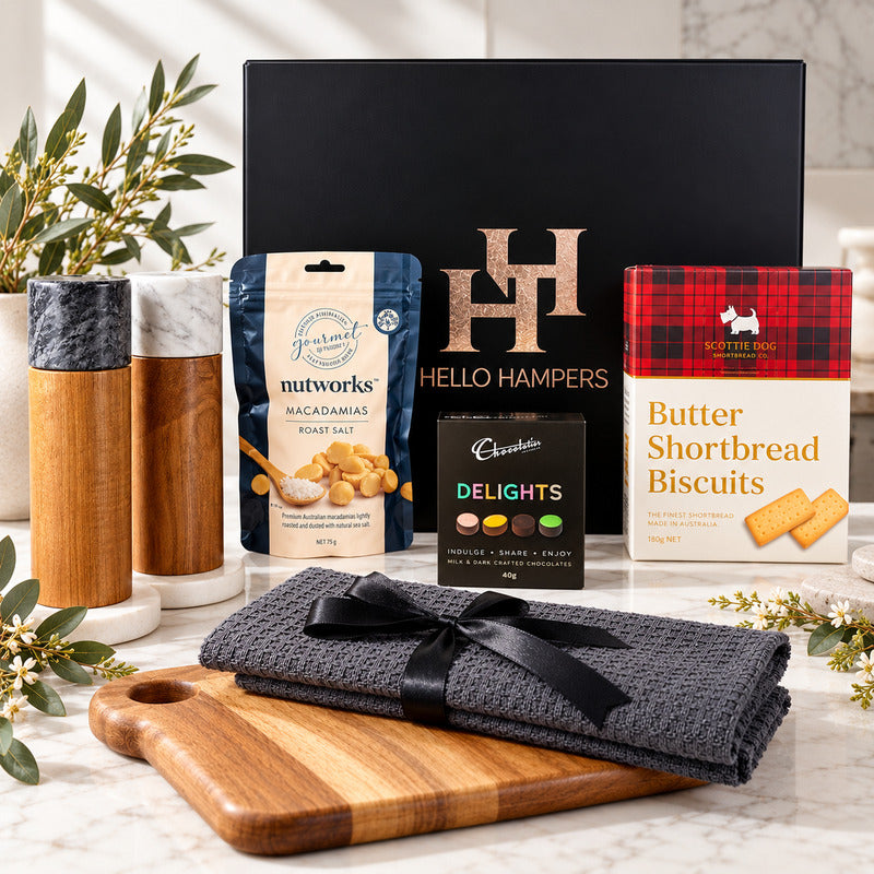 Hello Hampers settlement gift hamper with wooden board, two marble-topped grinders, kitchen cloths and gourmet treats